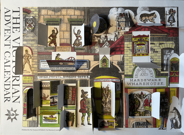 Victorian-themed advent calendar shown with the windows open revealing various scenes and objects such as a harlequin and a toy theatre
