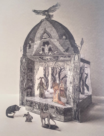 A three-dimensional paper toy theatre featuring a gothic-style magical show scene, with a bird perched on the roof, and various magical characters, perhaps sorcerers or witches, on the stage. Further small figures and animals stand in the foreground in front of the theatre.